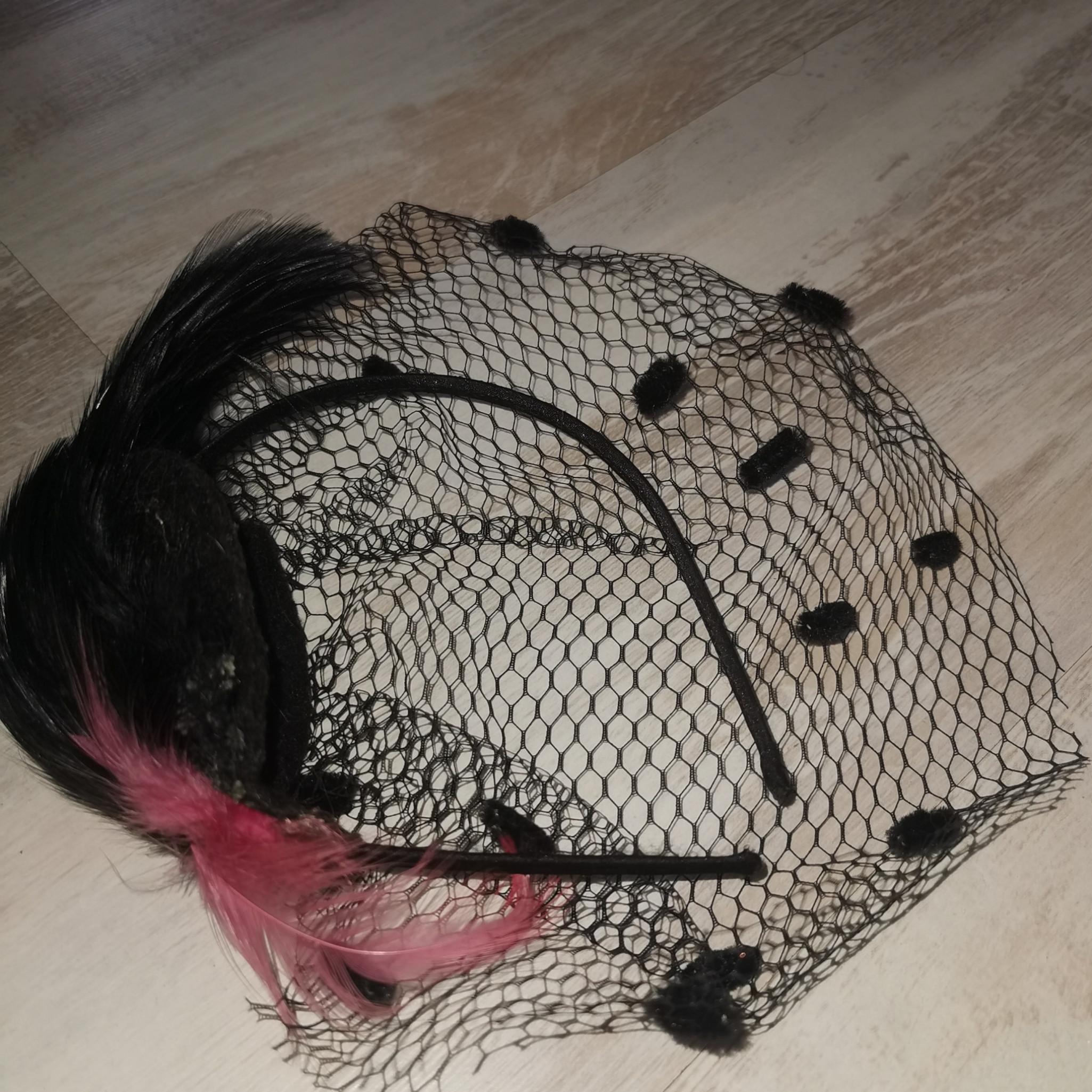 Pink and black feathered rich widow alice band with netting